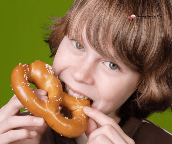 boy eating pretzel for free pretzel day in New Jersey