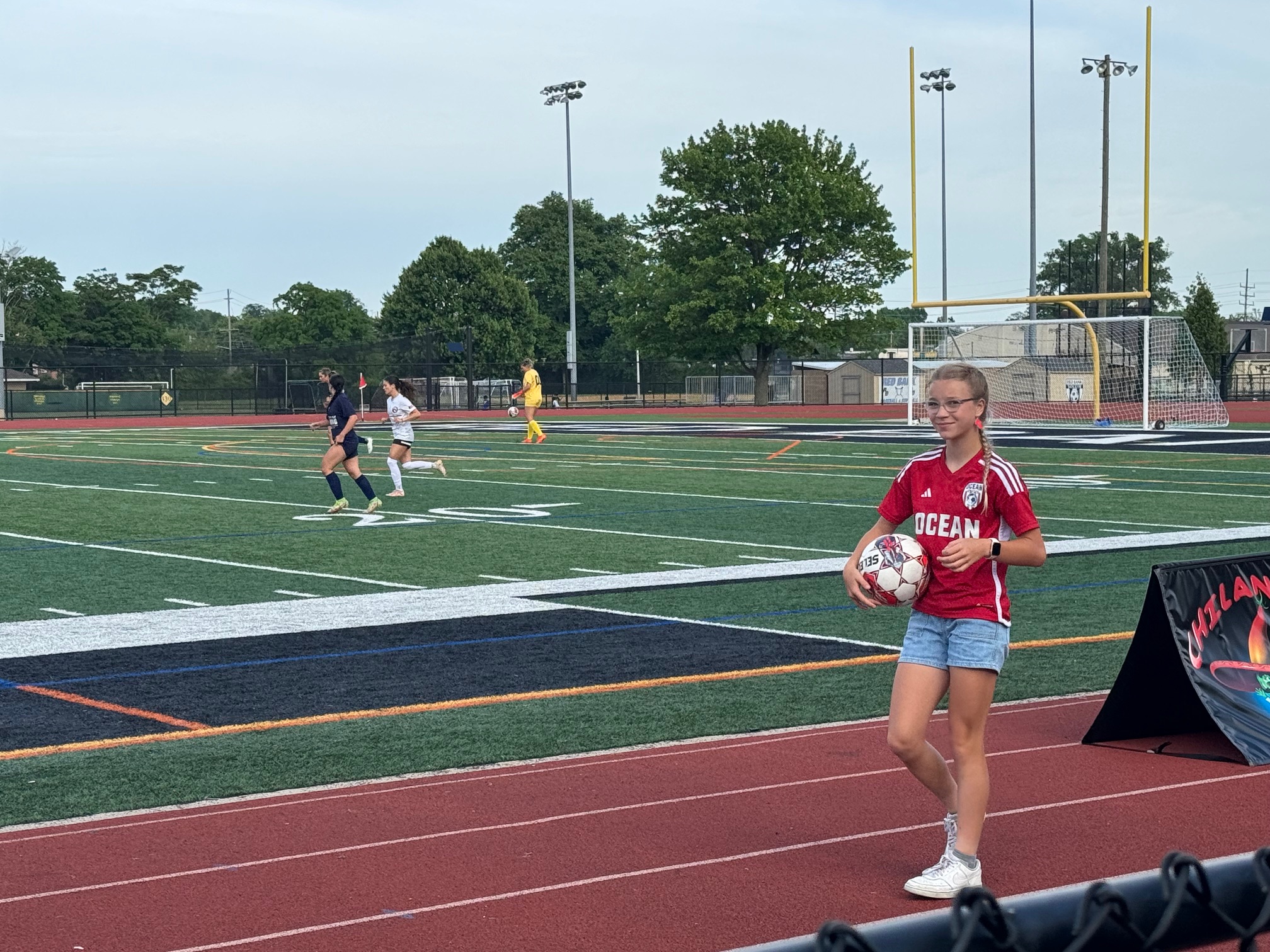 FC Monmouth Semi Pro Soccer teenage girl serves as ball girl